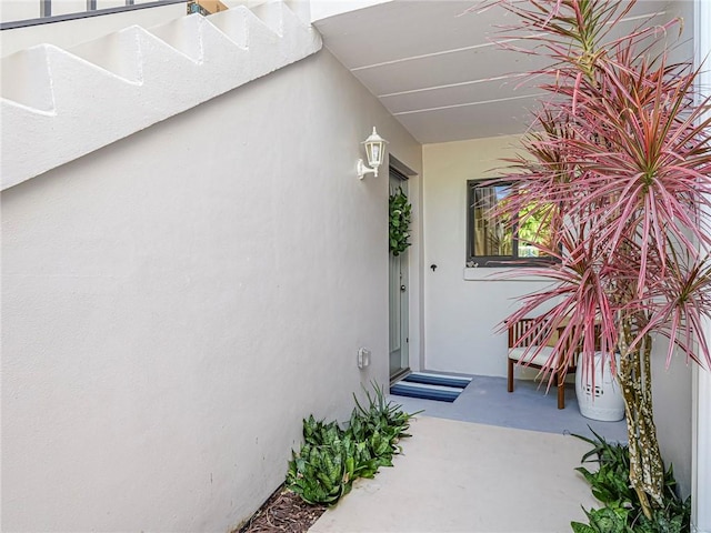 doorway to property featuring stucco siding