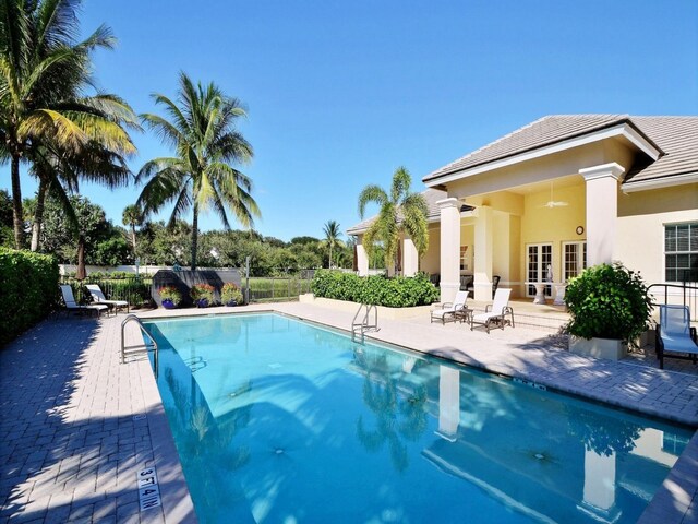 view of pool with french doors and a patio area