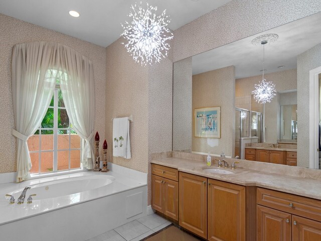 bathroom featuring vanity, tile patterned floors, an inviting chandelier, and separate shower and tub