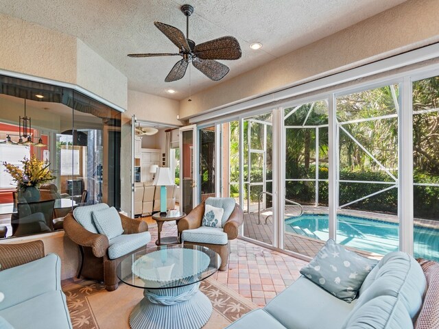 sunroom / solarium featuring ceiling fan and a healthy amount of sunlight