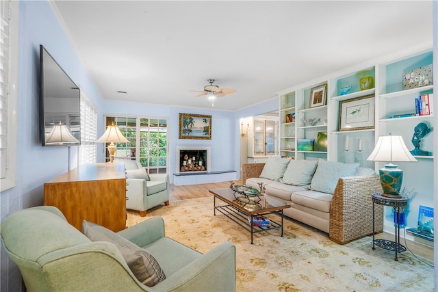 living room featuring ceiling fan and light wood-type flooring