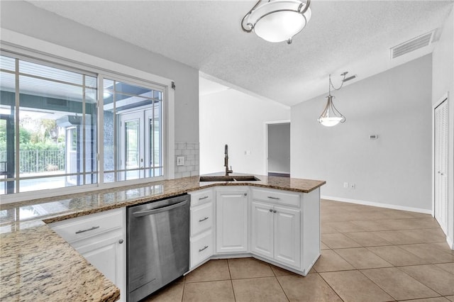 115 Larchmont Ter, Sebastian, FL 32958 - kitchen featuring stainless steel dishwasher, vaulted ceiling, light tile patterned floors, a textured ceiling, and white cabinets