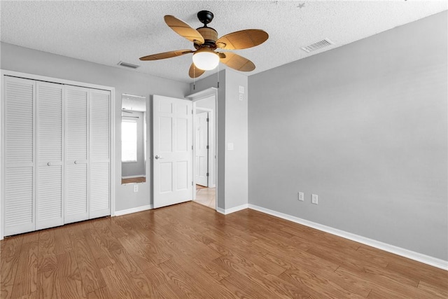 115 Larchmont Ter, Sebastian, FL 32958 - unfurnished bedroom with wood finished floors, a textured ceiling, a closet, and a ceiling fan