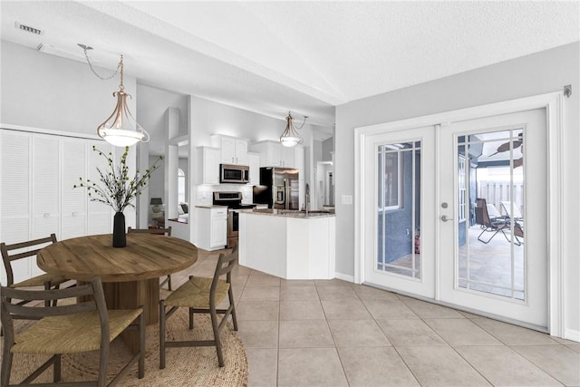 115 Larchmont Ter, Sebastian, FL 32958 - dining area featuring lofted ceiling, french doors, and light tile patterned flooring
