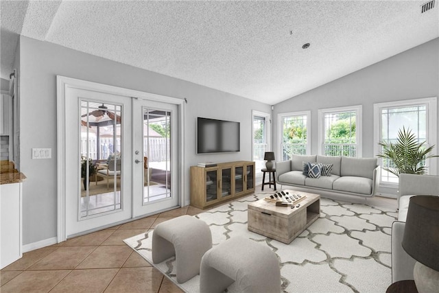 115 Larchmont Ter, Sebastian, FL 32958 - living room featuring a textured ceiling, french doors, lofted ceiling, and tile patterned floors