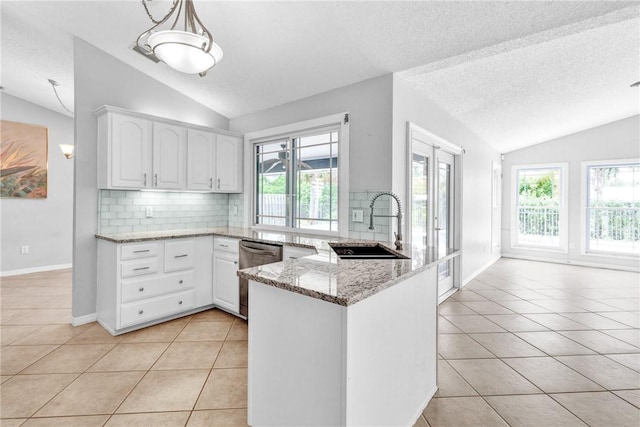 115 Larchmont Ter, Sebastian, FL 32958 - kitchen featuring lofted ceiling, dishwasher, light tile patterned flooring, a peninsula, and backsplash