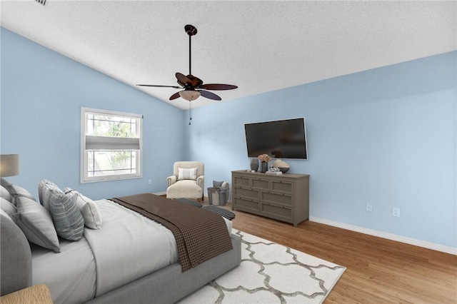 115 Larchmont Ter, Sebastian, FL 32958 - bedroom featuring wood finished floors, lofted ceiling, a textured ceiling, and a ceiling fan