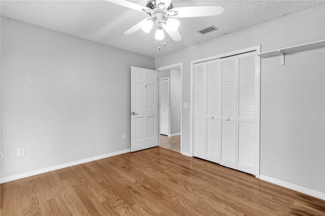 115 Larchmont Ter, Sebastian, FL 32958 - unfurnished bedroom featuring wood finished floors, a closet, and a ceiling fan
