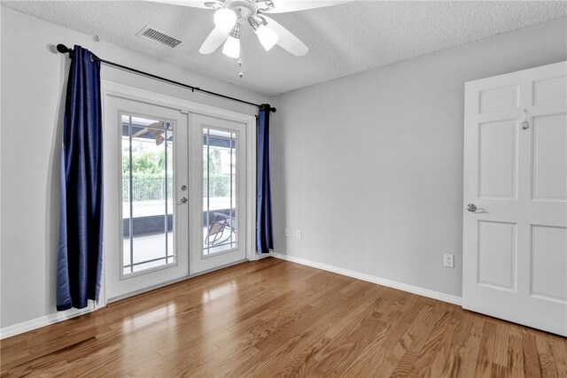 115 Larchmont Ter, Sebastian, FL 32958 - empty room with french doors, wood finished floors, a textured ceiling, and ceiling fan