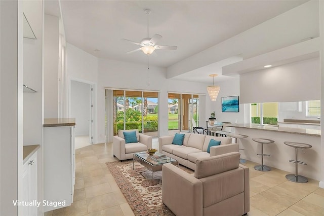 living room featuring light tile patterned flooring and ceiling fan