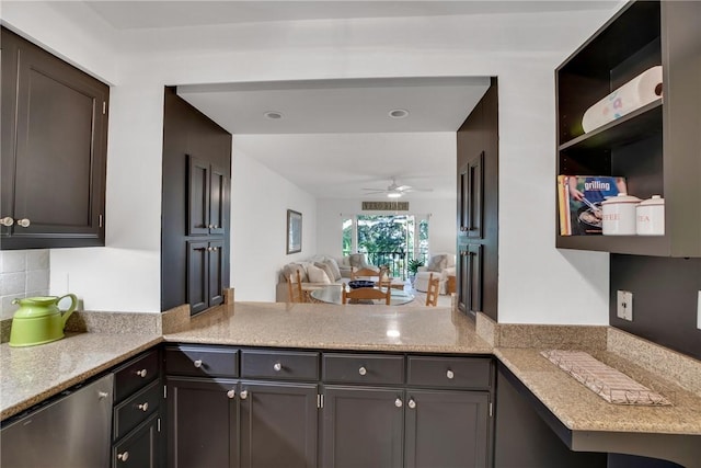 kitchen with ceiling fan, dark brown cabinets, kitchen peninsula, and tasteful backsplash