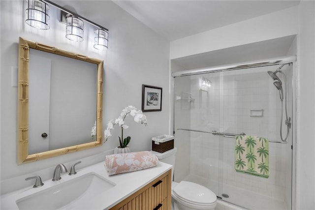 bathroom with vanity, an enclosed shower, and toilet