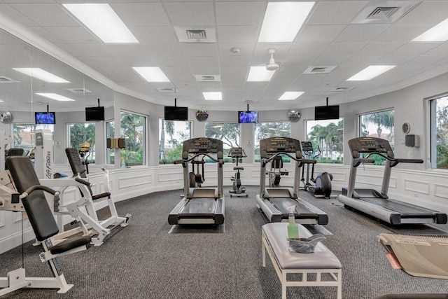 exercise room with a decorative wall, a drop ceiling, and visible vents