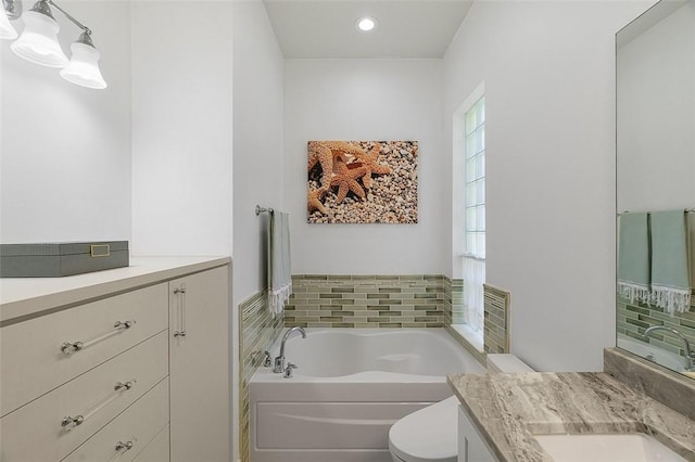 full bath featuring toilet, a bath, recessed lighting, and vanity