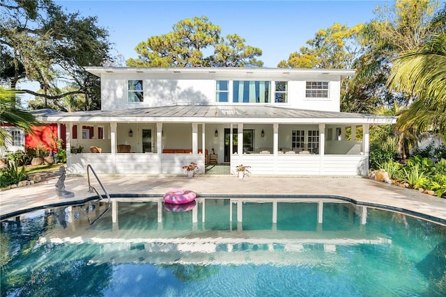 rear view of property with a patio area and a sunroom