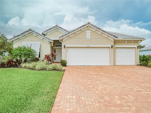 view of front of house featuring a garage and a front lawn