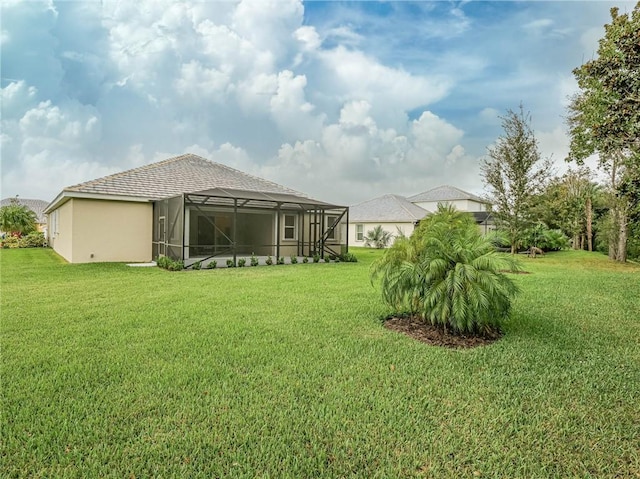 view of yard with glass enclosure