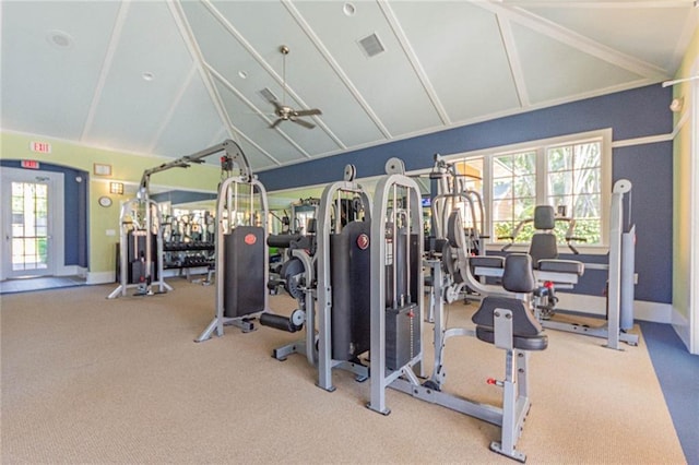 gym with ceiling fan, a healthy amount of sunlight, and vaulted ceiling