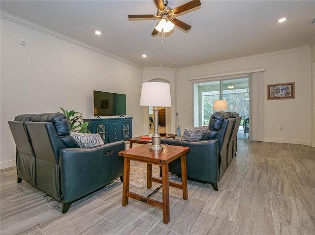 living room with ceiling fan and ornamental molding