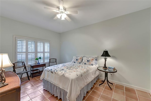 tiled bedroom featuring ceiling fan