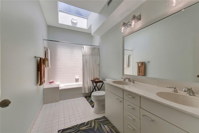 full bathroom featuring tile patterned floors, toilet, a skylight, vanity, and shower / bath combo