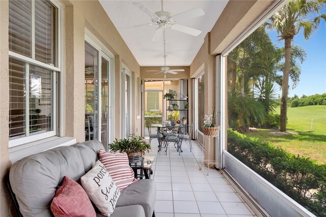 sunroom / solarium with a wealth of natural light and ceiling fan