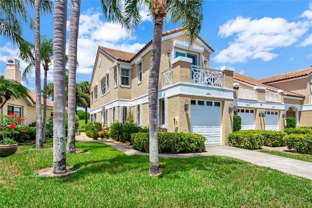 4851 N Newport Island Dr Unit 12A, Vero Beach, FL 32967 - townhome / multi-family property with stucco siding, concrete driveway, a front yard, a tile roof, and a balcony