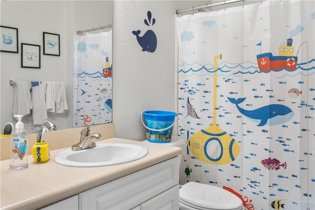 bathroom with vanity, a shower with shower curtain, and toilet