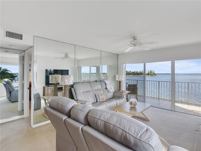 carpeted living room featuring ceiling fan