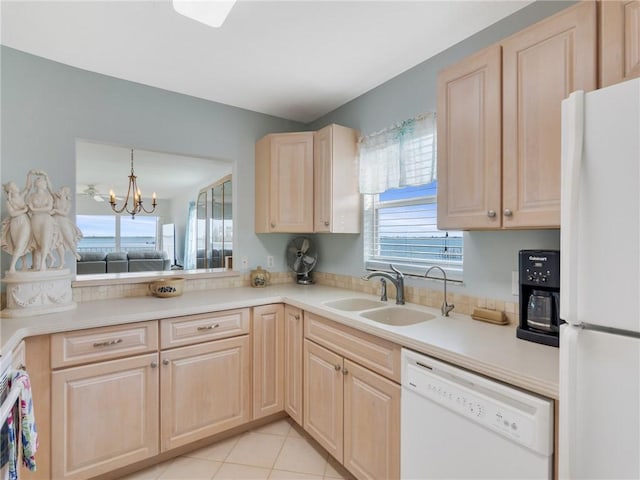 kitchen with a notable chandelier, plenty of natural light, white appliances, and sink