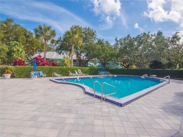 view of swimming pool with a patio