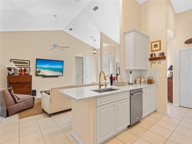 kitchen with light tile patterned floors, white cabinetry, and sink