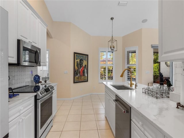 kitchen featuring white cabinetry, sink, a chandelier, and appliances with stainless steel finishes