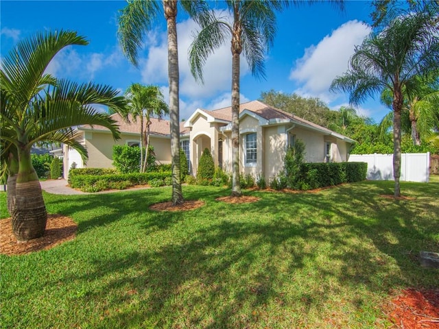 mediterranean / spanish-style home featuring a front lawn