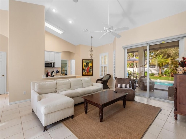 living room with light tile patterned floors, high vaulted ceiling, and ceiling fan