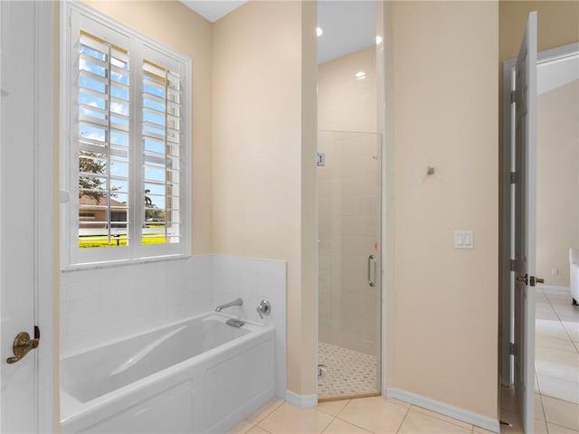 bathroom featuring tile patterned flooring and independent shower and bath