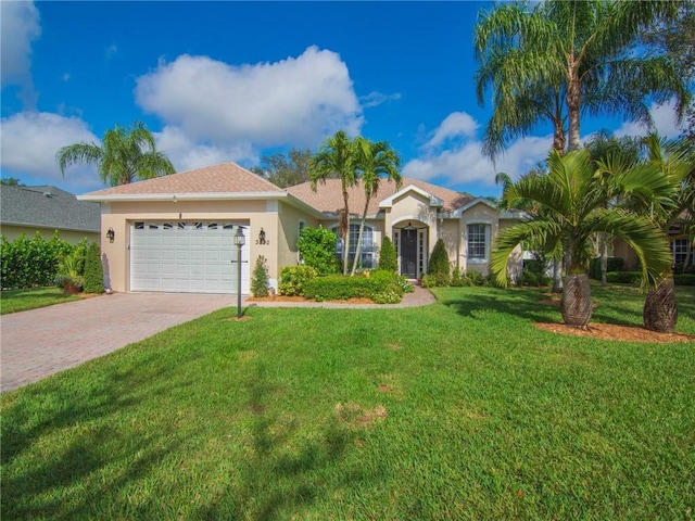 view of front facade with a garage and a front lawn