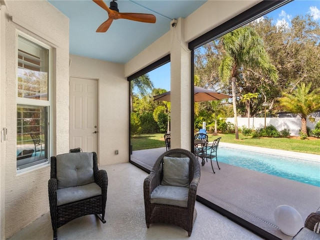 sunroom / solarium featuring ceiling fan