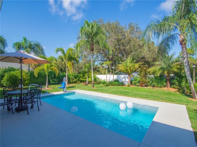 view of pool featuring a patio area and a yard