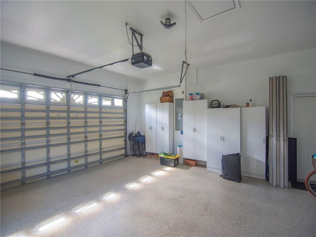 garage with electric panel and a garage door opener