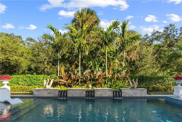 view of swimming pool featuring pool water feature