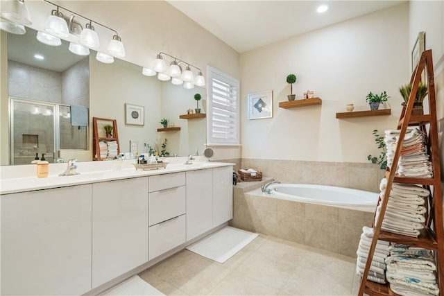 bathroom with independent shower and bath, vanity, and tile patterned floors