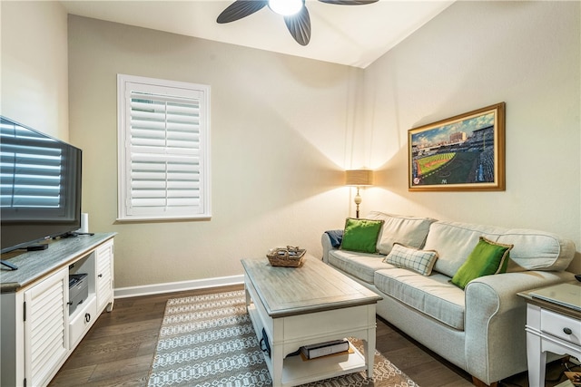 living room featuring ceiling fan and dark hardwood / wood-style flooring