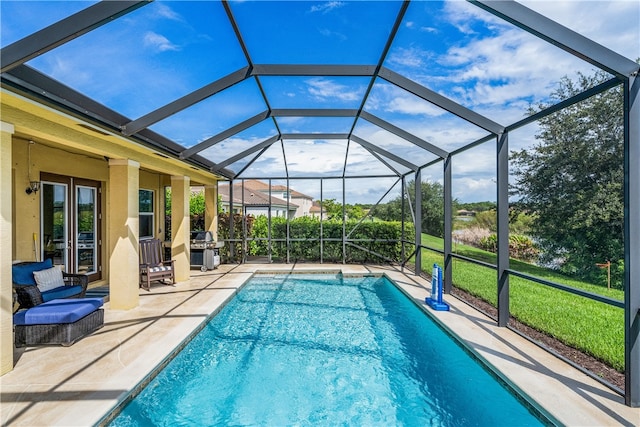 view of swimming pool with a grill, glass enclosure, and a patio