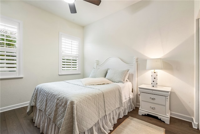 bedroom with dark wood-type flooring, multiple windows, and ceiling fan