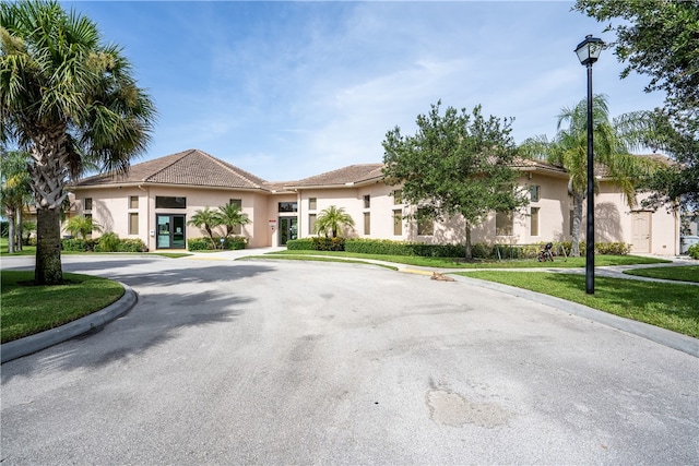 mediterranean / spanish-style home with a front lawn