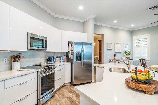 kitchen with white cabinetry, light wood-type flooring, appliances with stainless steel finishes, and crown molding