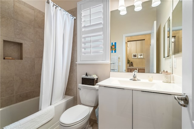 full bathroom featuring shower / bath combo with shower curtain, vanity, and toilet