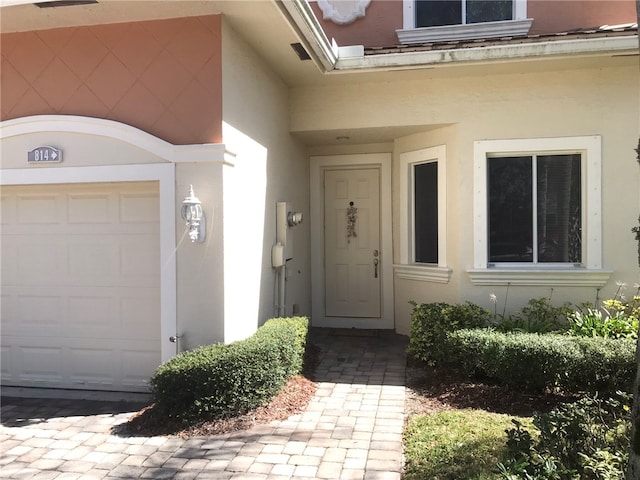 view of exterior entry featuring a garage