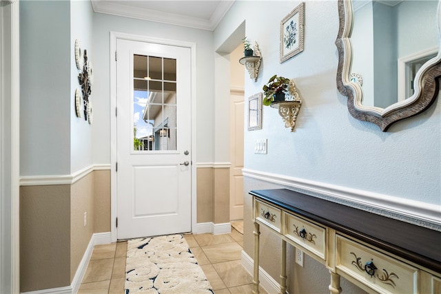 entryway with light tile patterned floors and crown molding